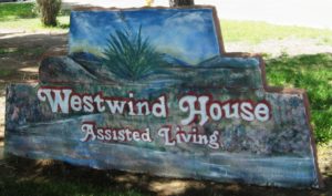 Sign from Westwind House that reads "Assisted Living" and is painted on a rock.