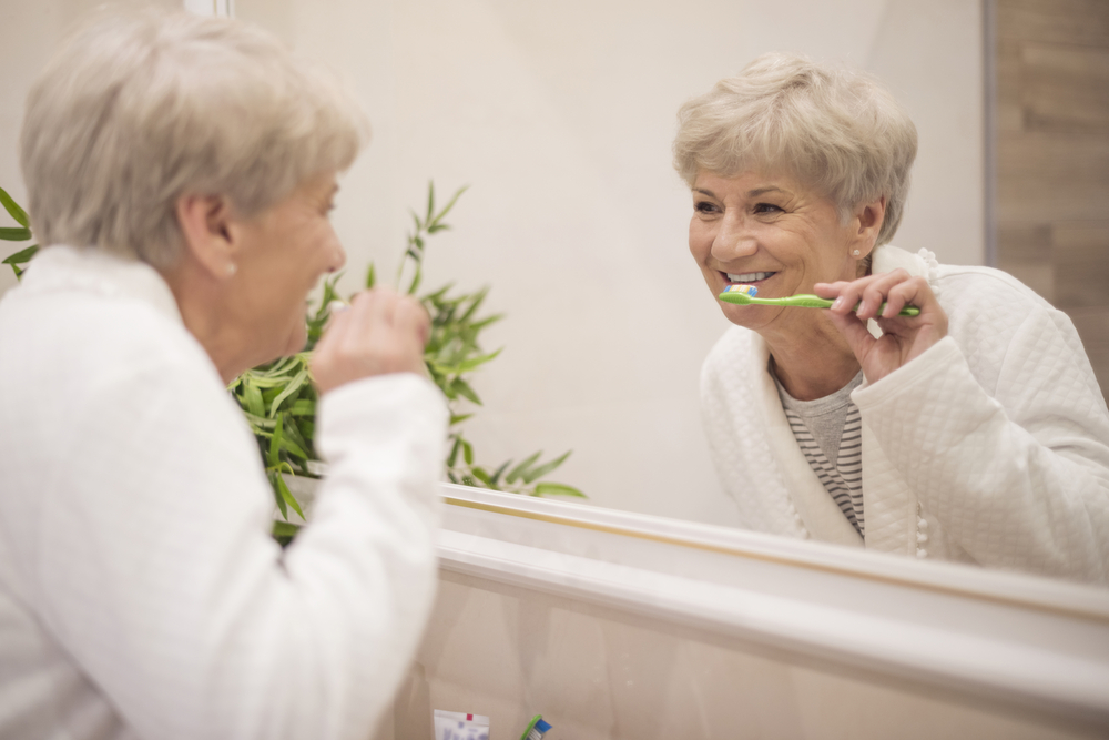 senior-brushing-teeth-mirror